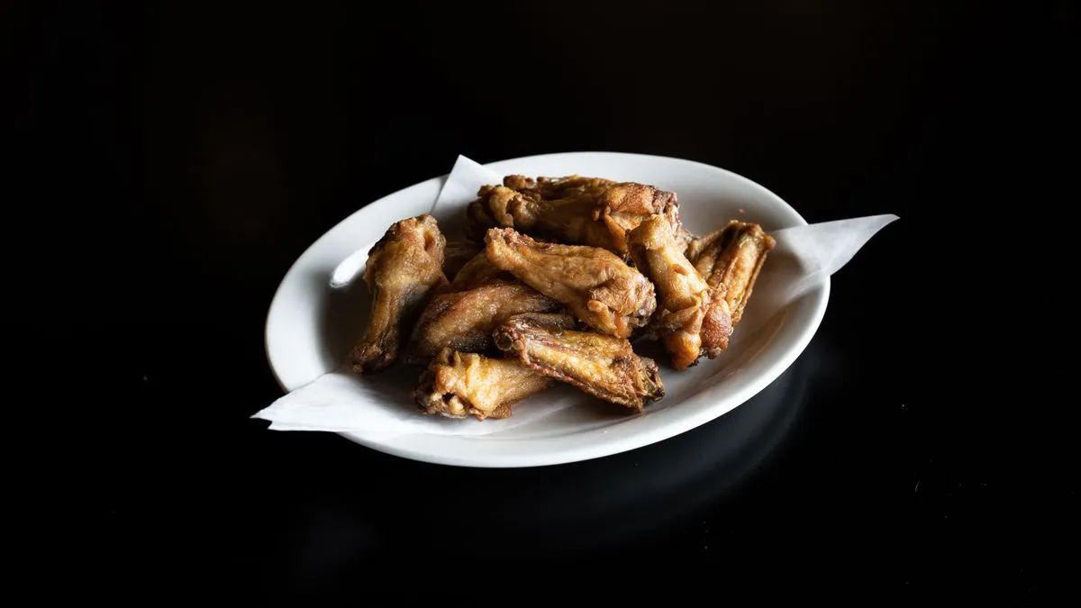 A single Nashville-style hot chicken tender — the cheapest item at Dave's Hot Chicken
