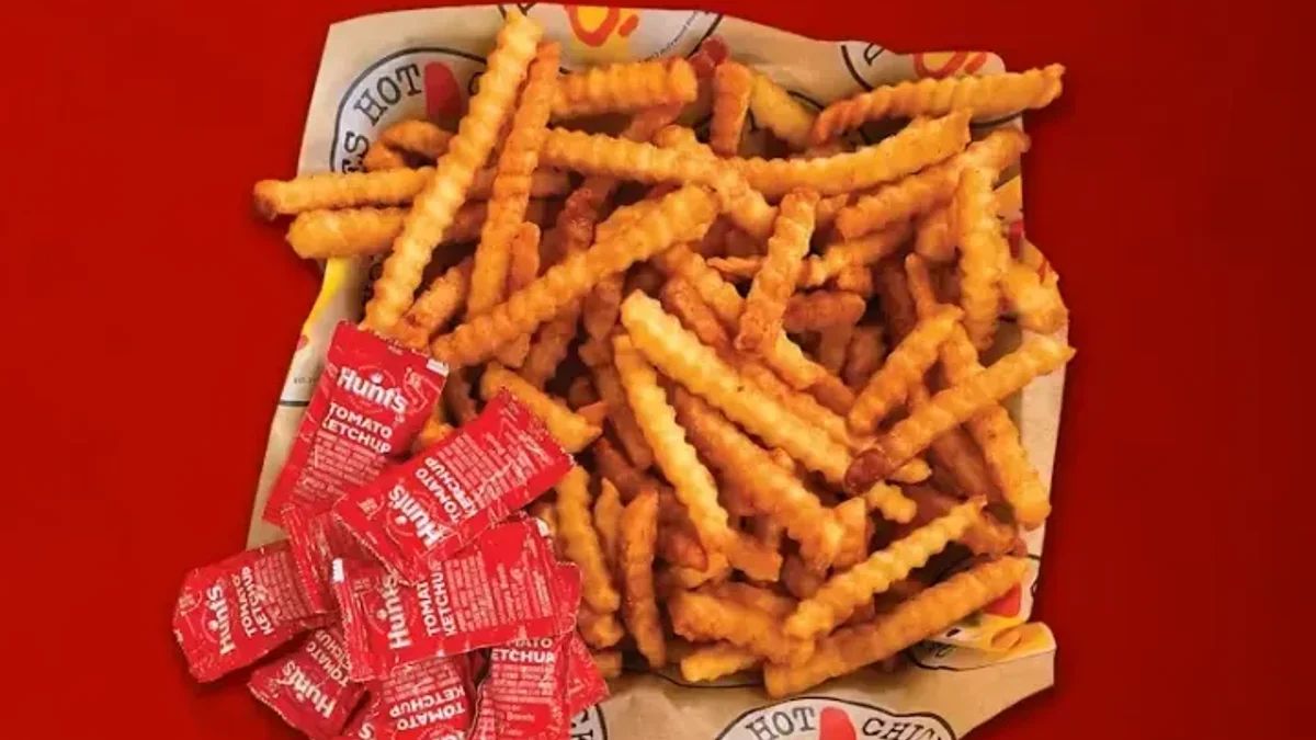 A box of Dave's Hot Chicken crinkle fries — the base for build-your-own loaded fries