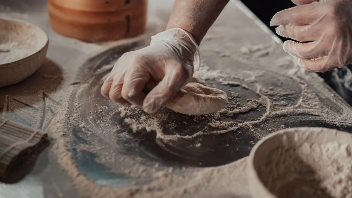 Dredging chicken in seasoned flour — the double-dredge step for copycat Dave's Hot Chicken