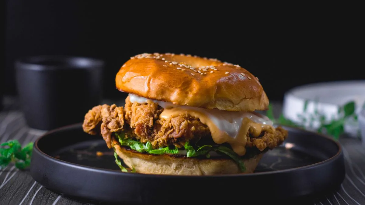 A finished Nashville-style hot chicken slider on a toasted bun — copycat Dave's Hot Chicken assembled