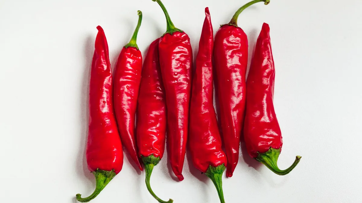 Dried red cayenne peppers on a white surface — cayenne is the base of the Dave's Hot Chicken rub