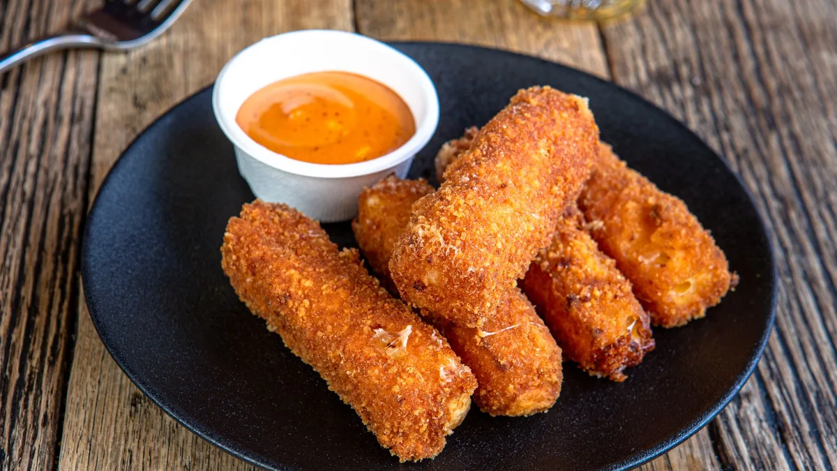 Crispy fried mozzarella sticks with dipping sauce — how to order Dave's Hot Mozz